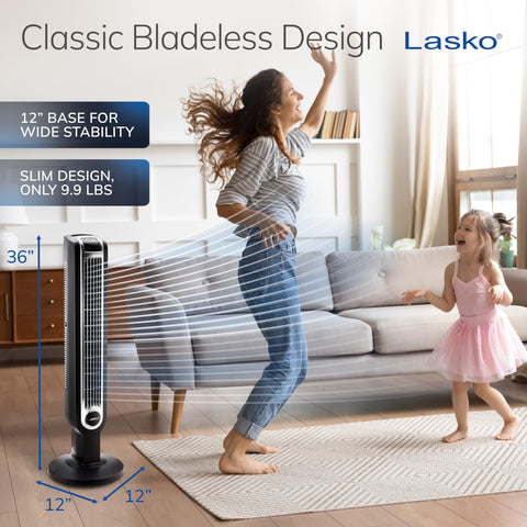 Lasko oscillating tower fan in bedroom setup delivering gentle airflow.