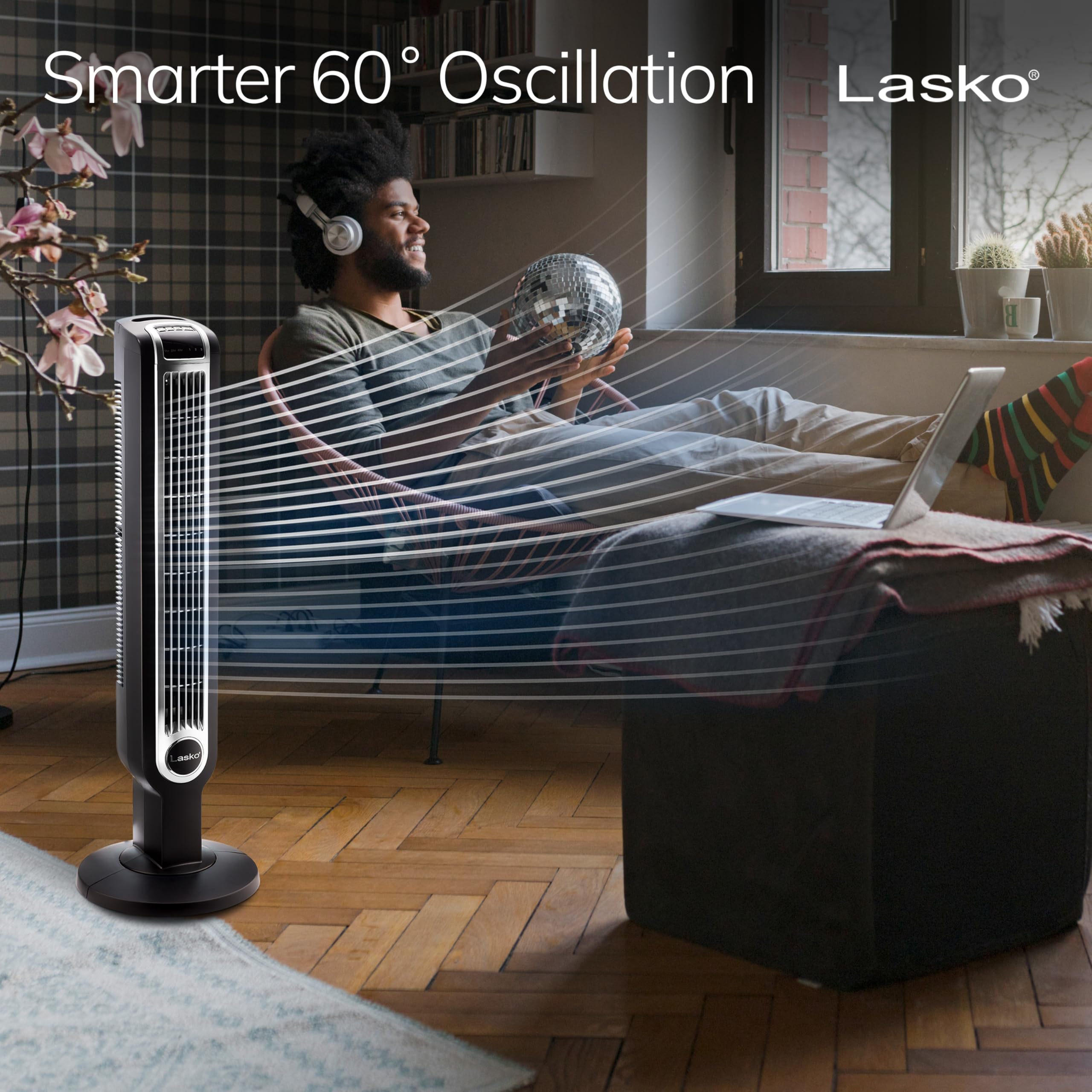 Lasko oscillating tower fan in action illustrating wide oscillation for even room airflow.