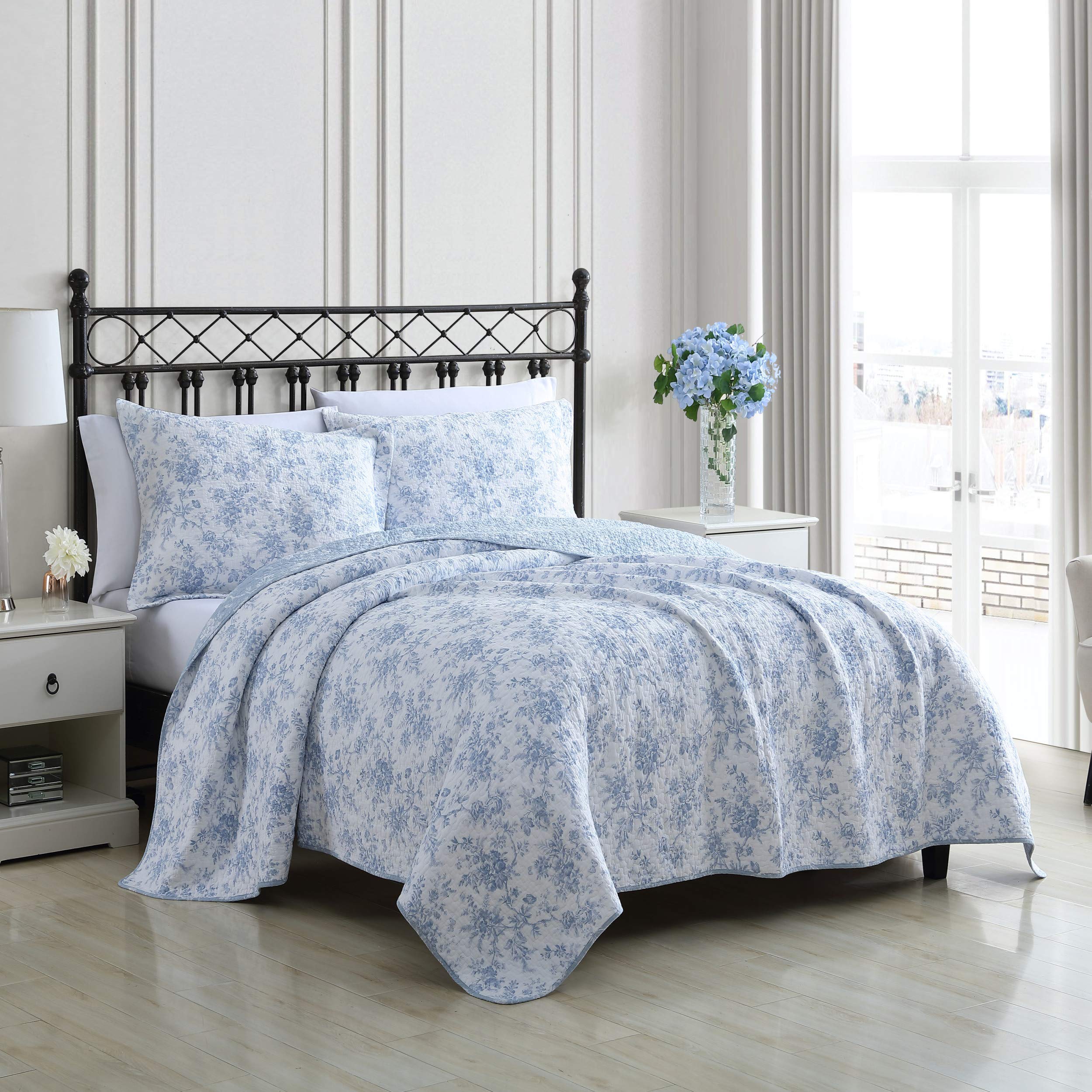 Laura Ashley reversible floral quilt blue side displayed to emphasize styling options