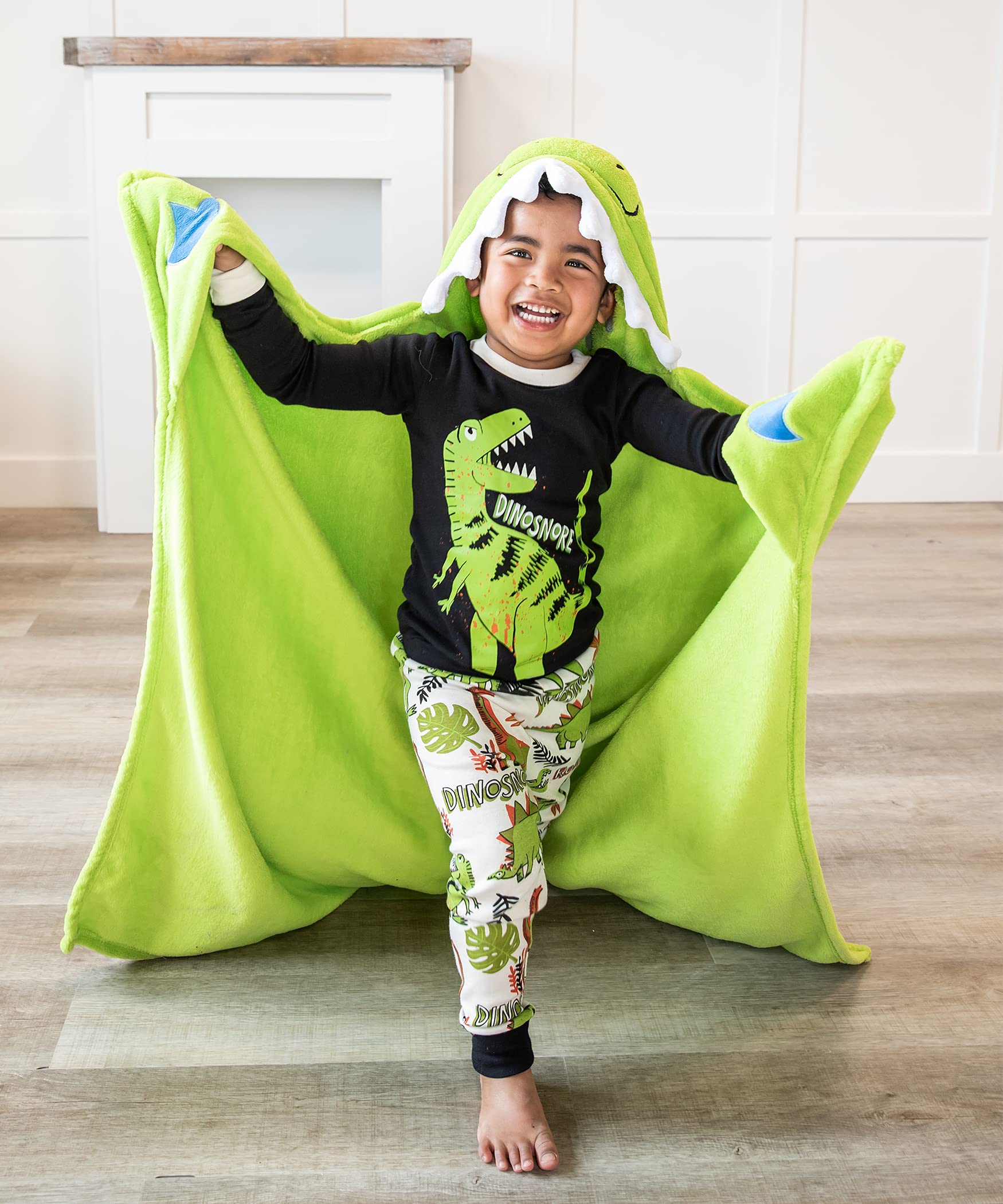 Lazy One dinosaur hooded blanket worn by kids during cozy lounging.