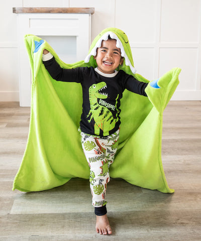 Lazy One dinosaur hooded blanket worn by kids during cozy lounging.