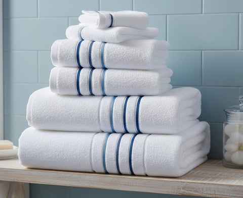 Le fil blanc bath towels 55'' x 28'' with azure stripe for luxurious drying.