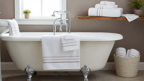 Le fil blanc complete towel set stacked in a bathroom, ready for daily use.