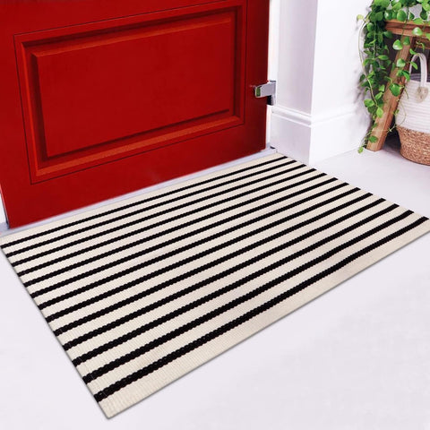 LEEVAN modern black white stripes rug enhances curb appeal while withstanding outdoor wear.