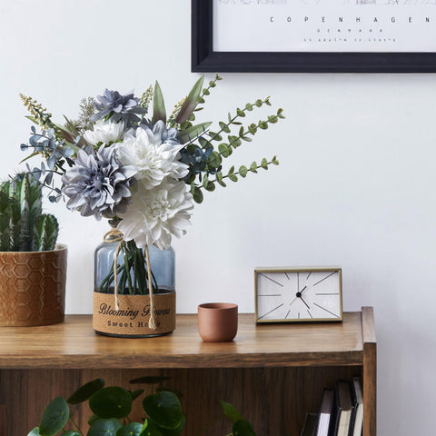 Leftover silk flowers in vase stay vibrant year-round.
