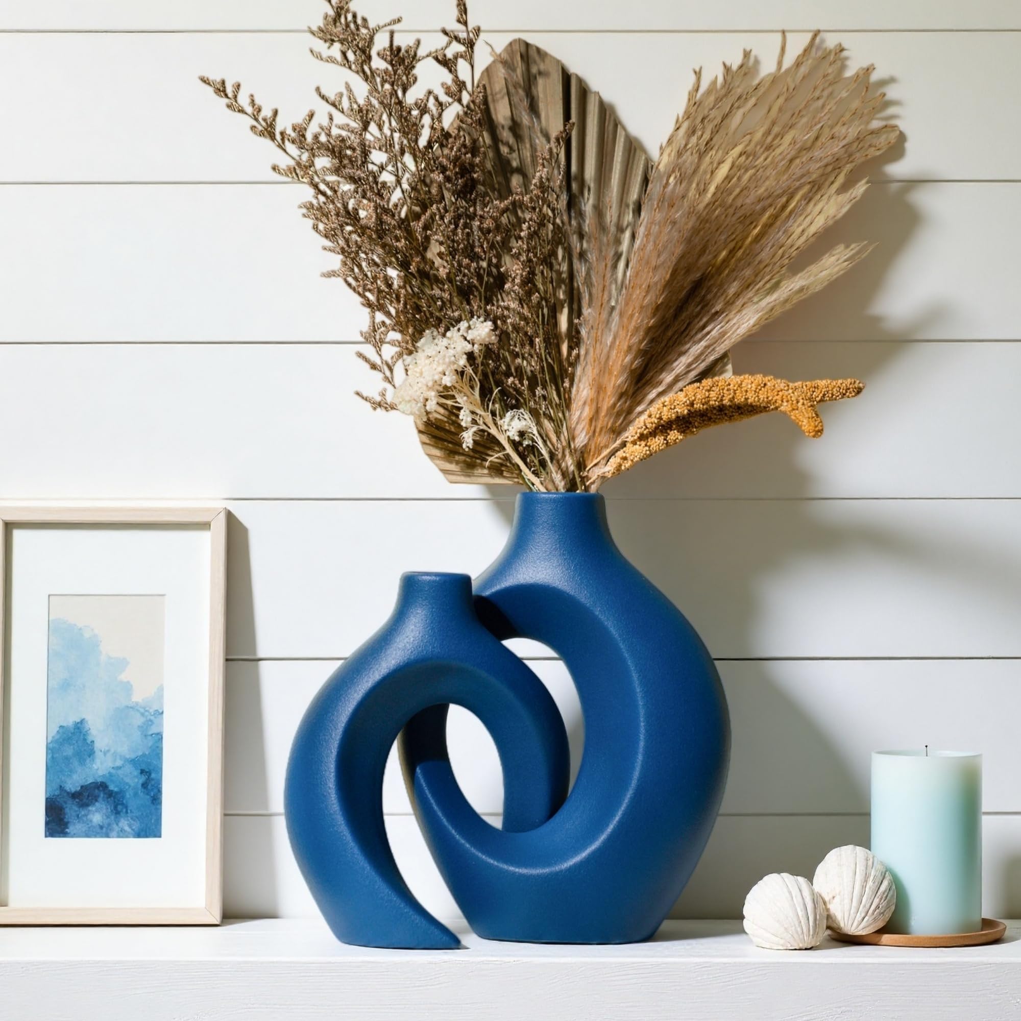 Levvohd Snuggle Hollow heart design navy vase serves as a focal piece.
