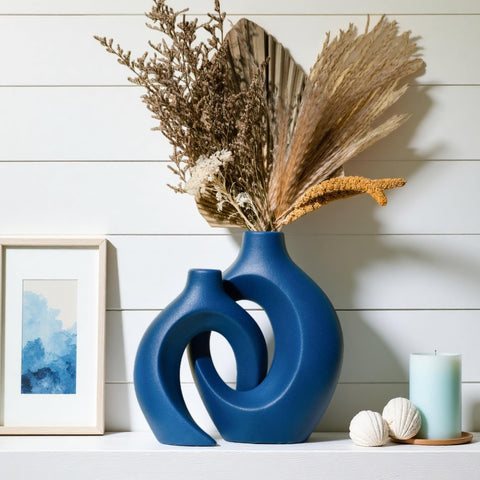 Levvohd Snuggle Hollow heart design navy vase serves as a focal piece.