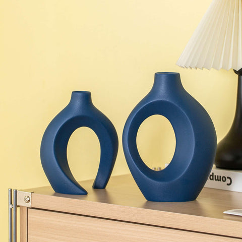 Levvohd Snuggle Hollow vase with dried flowers in navy finish.