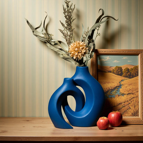 Levvohd Snuggle Hollow navy vase adds a modern boho touch.