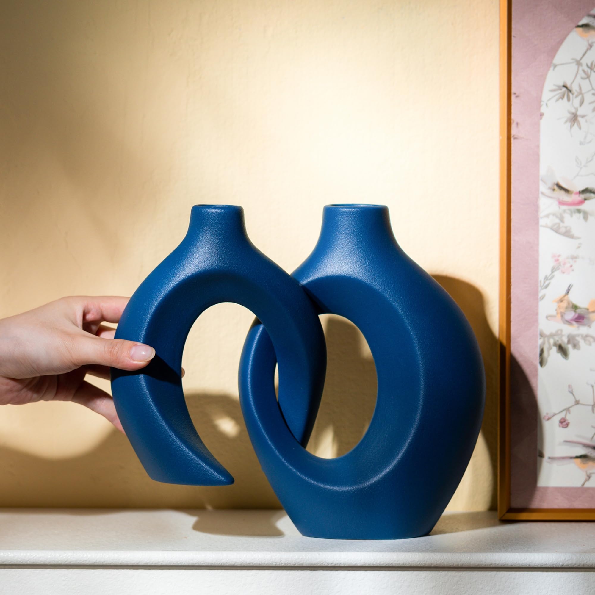 Levvohd Snuggle Hollow navy vase on a shelf elevates room decor.