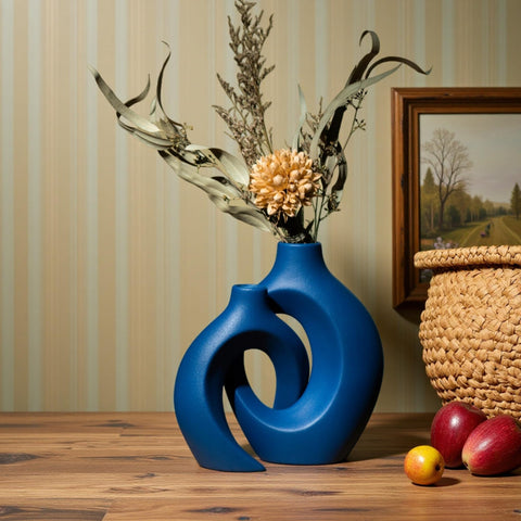 Levvohd Snuggle Hollow navy vase paired with pampas grass for texture.