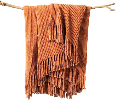 lifein throw blanket on couch in burnt orange offers cozy year-round comfort.