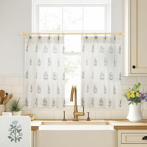 Lino Rosa cafe curtains over kitchen sink with pinch-pleat design and blue-green floral print.