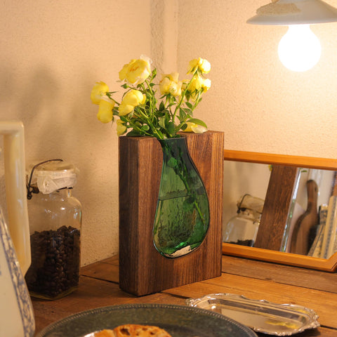 Litivy asymmetrical vase design on a sturdy wooden base for tall stems.