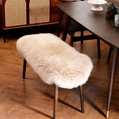 LLB sheepskin rug draped over chair in cream for cozy elegance