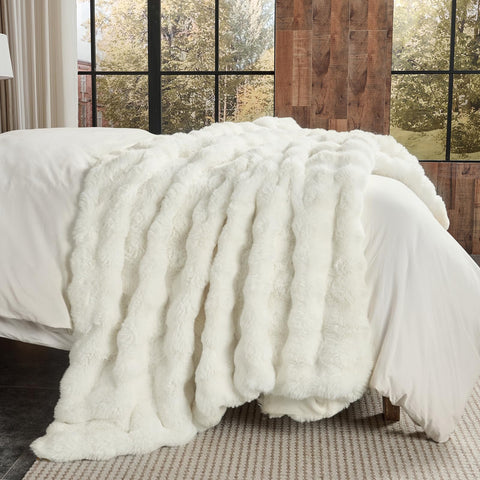 Lotus Karen blanket on sofa enhances living room decor.