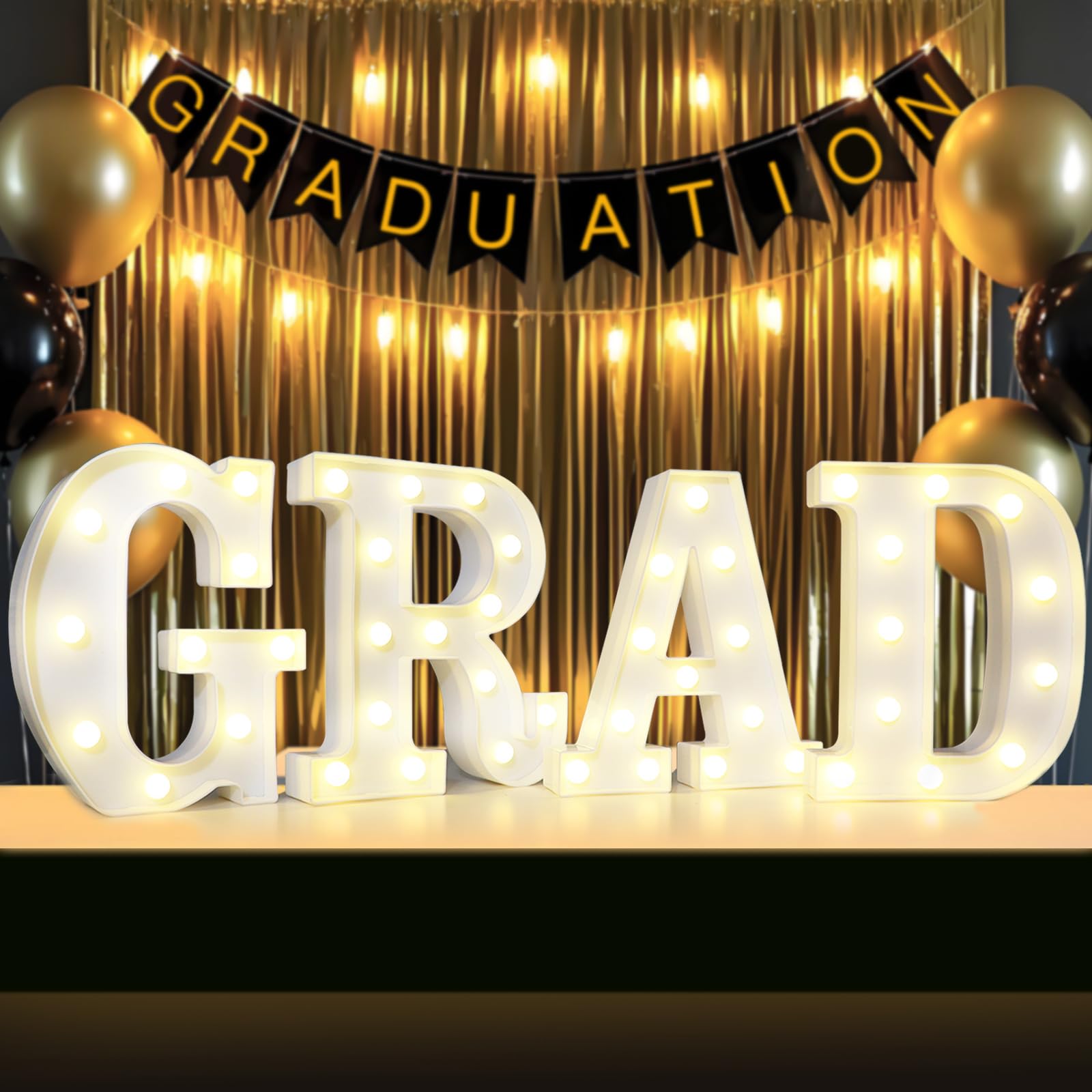 Lovelite GRAD sign four-letter set on a table centerpiece with warm glow