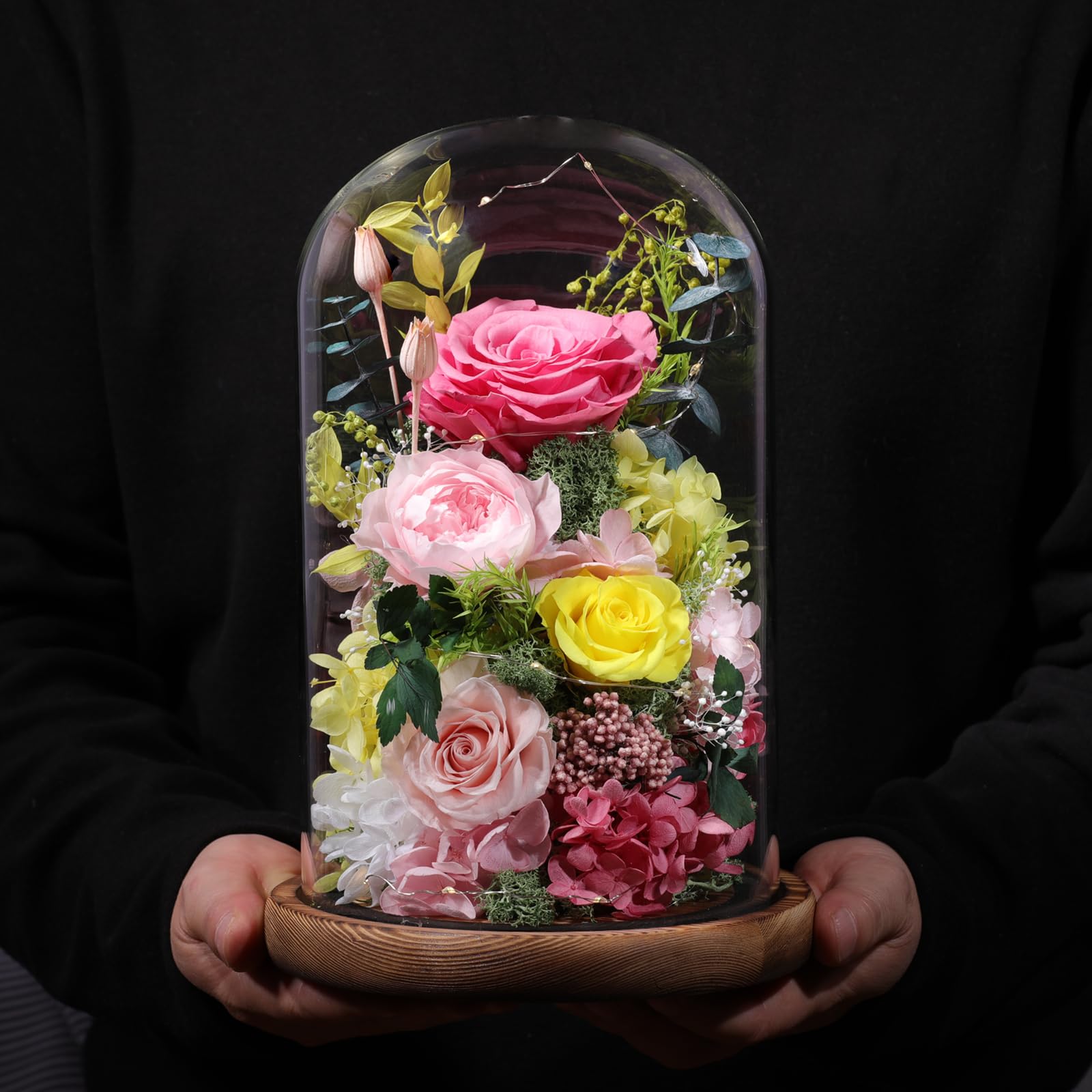Lovenfold glass dome with a softly lit bloom enhances gift presentation.