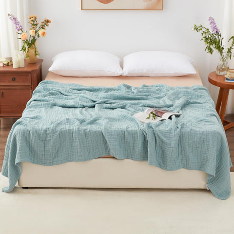 Love's cabin blanket in white draped over a sofa demonstrates lightweight warmth for year-round lounging.