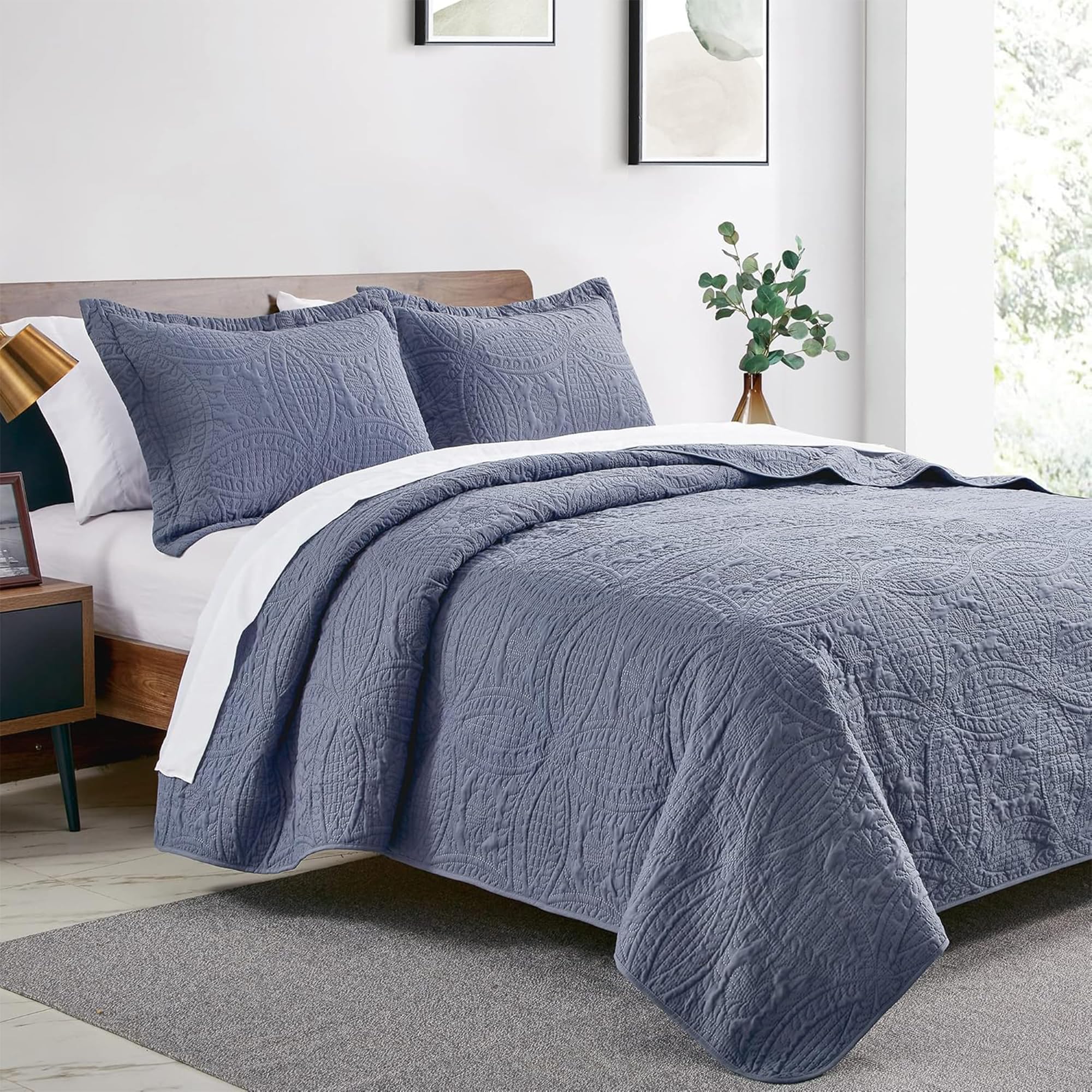 Love's cabin blue coin-pattern quilt shams provide a coordinated, easy-layering look.