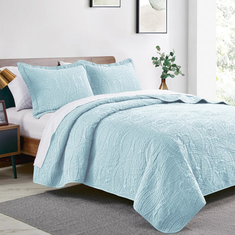Love's cabin coin-pattern coverlet closeup highlights durable stitching.