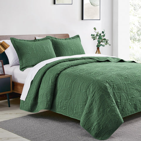 Love's cabin coin-pattern coverlet on a bed adds a stylish textured focal point.