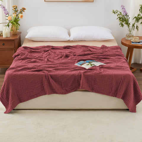 Love's Cabin muslin blanket on bed, soft touch ideal for cozy nights.