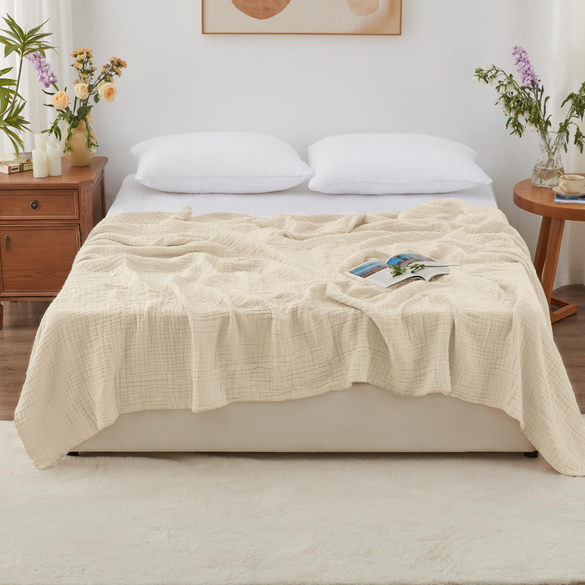 Love's cabin muslin blanket laid on a bed illustrates all-season comfort.