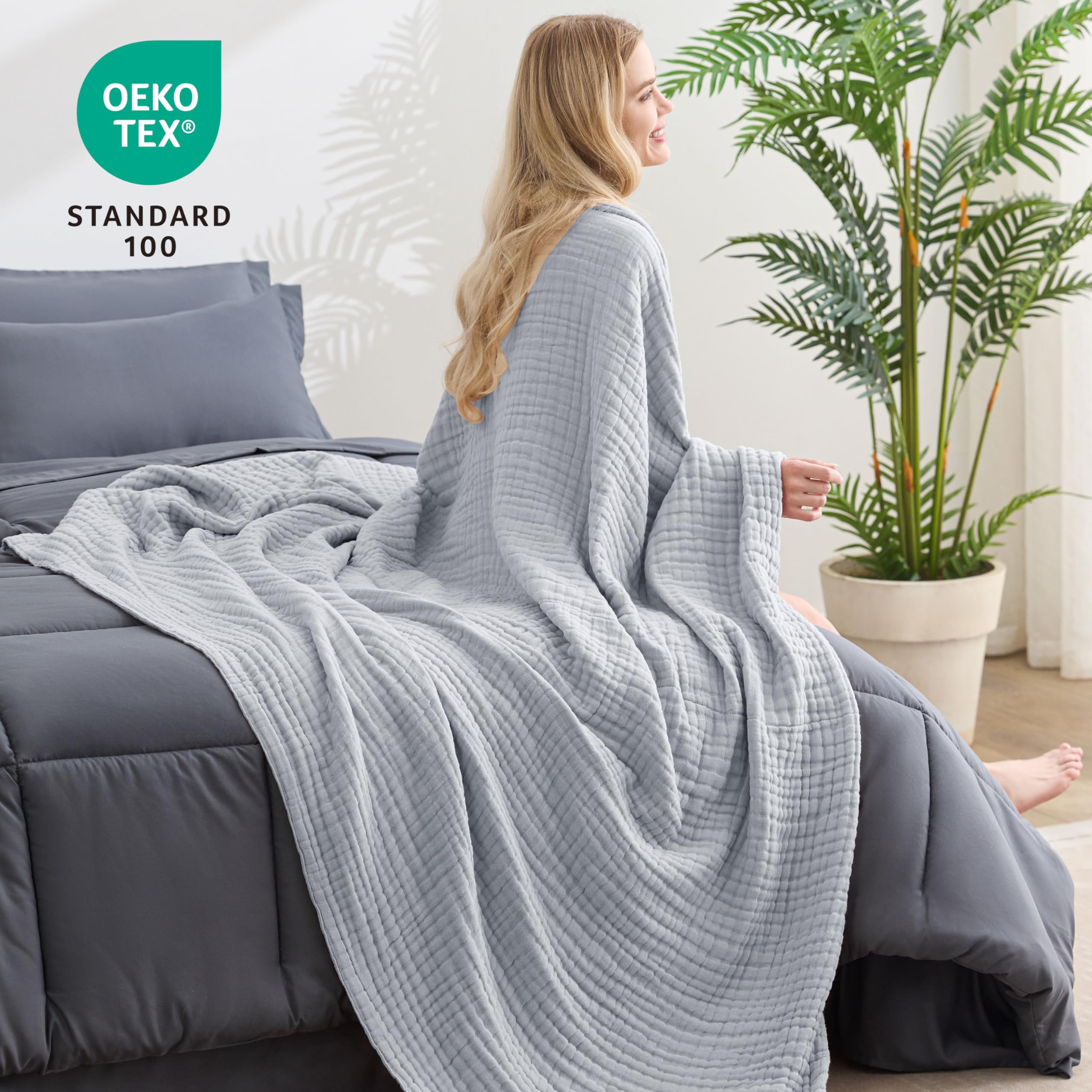 Light grey Love's cabin muslin blanket adds subtle style and comfort.
