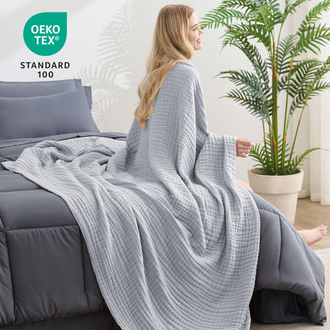 Light grey Love's cabin muslin blanket adds subtle style and comfort.