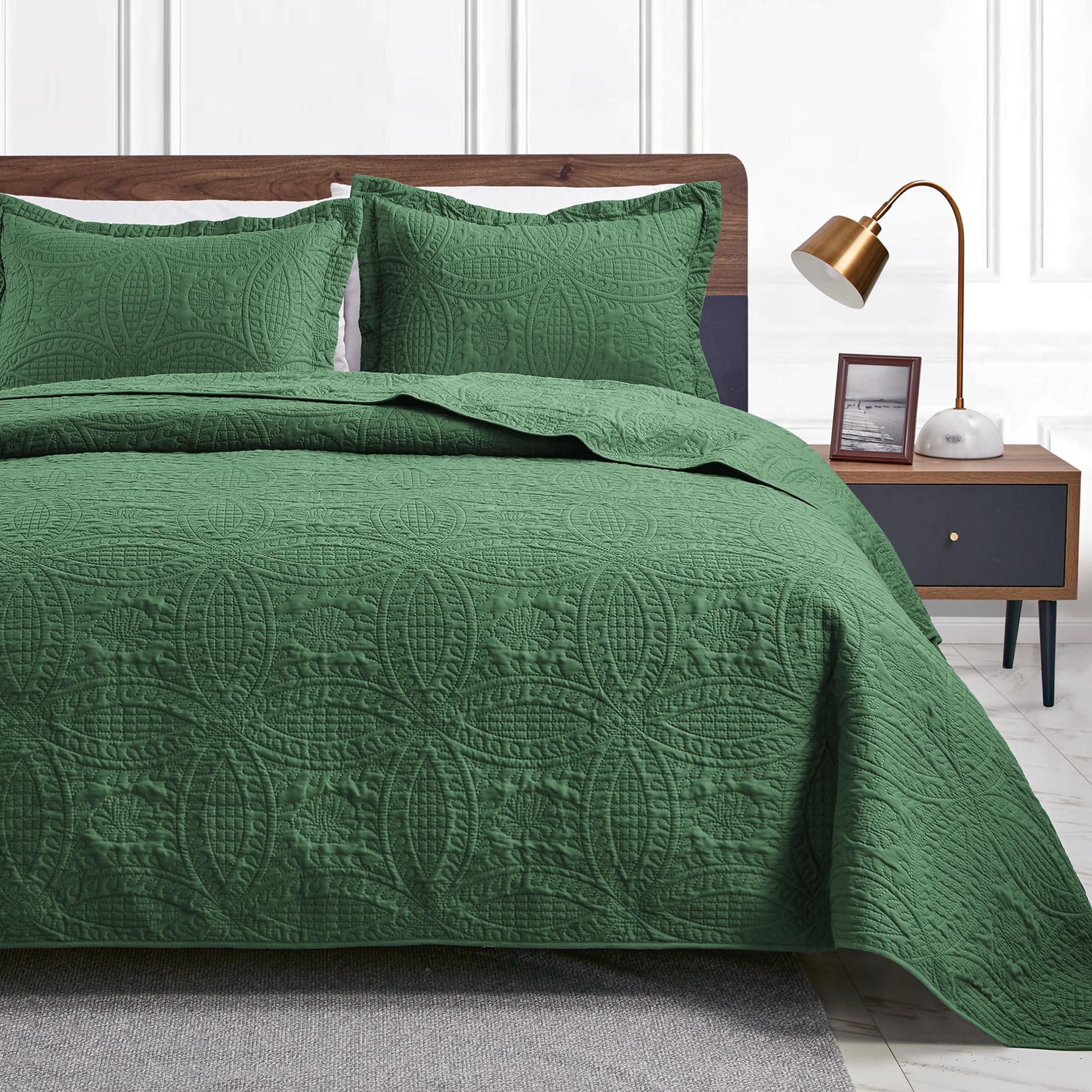 Love's cabin olive green king quilt set displayed on a neatly made bed for year-round comfort.