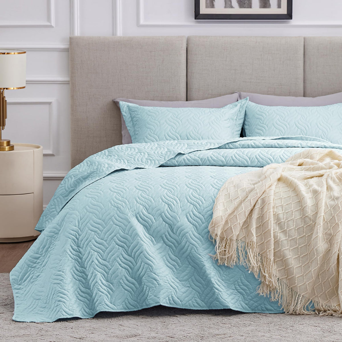 Love's cabin wave-pattern quilt in light blue adds soft texture to the bed.