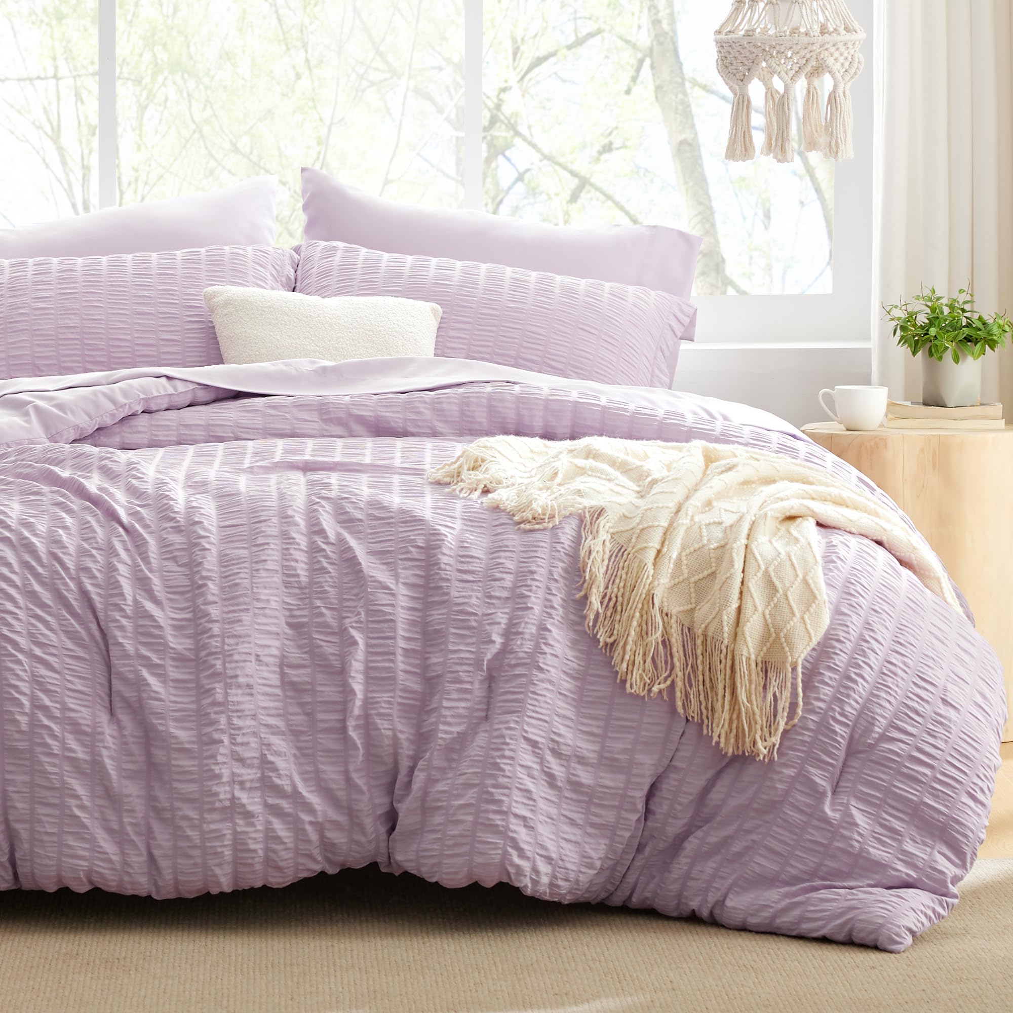 Love's cabin seersucker lavender twin comforter set on bed for all-season warmth.