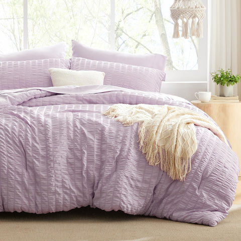 Love's cabin seersucker lavender twin comforter set on bed for all-season warmth.