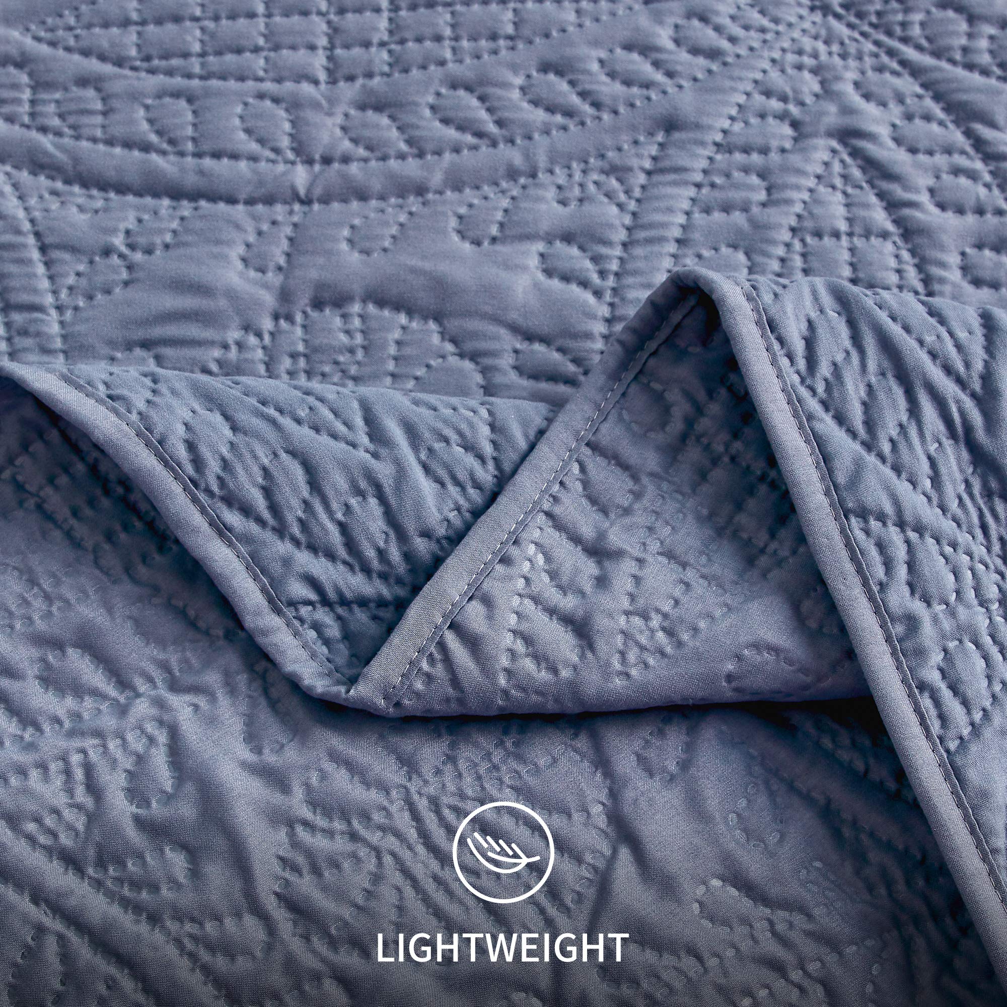 Twin quilt in blue layered with an extra blanket for versatile warmth.