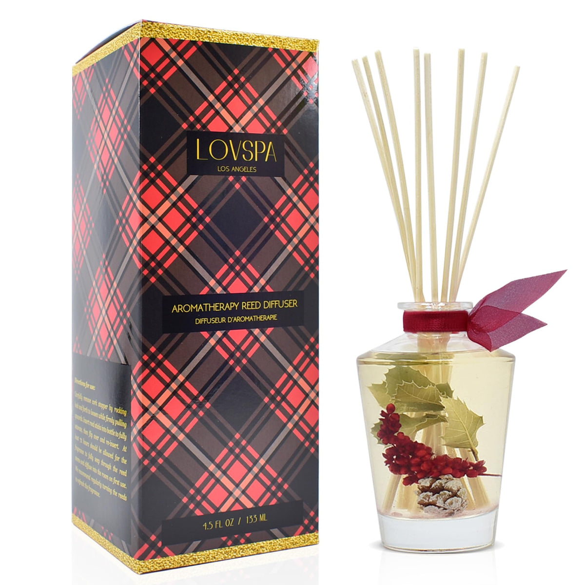 LOVSPA Holiday Red Currant Woods diffuser with glass bottle and reeds fills rooms with festive fragrance.