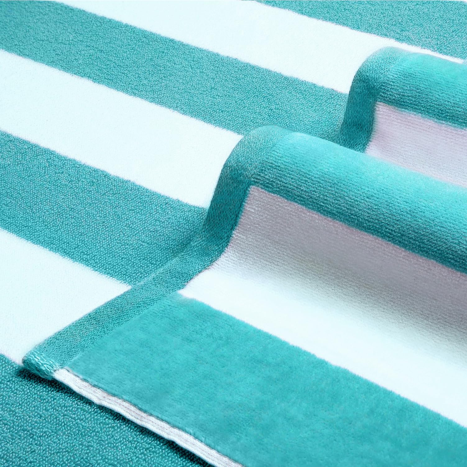 LULUHOME striped turquoise towel on the beach for stylish lounging.