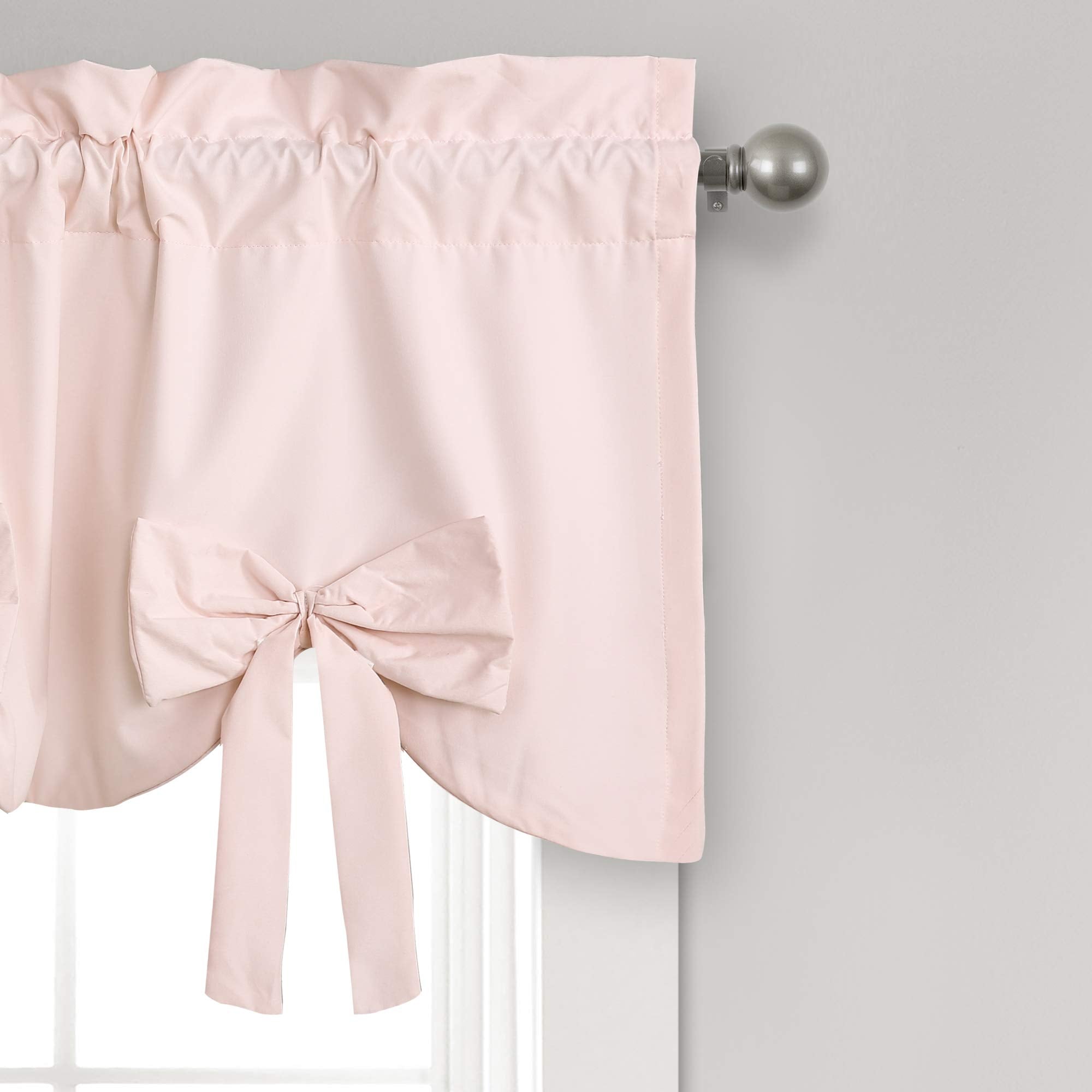 Soft scalloped hem and blush color brighten bathroom or nursery decor with light filtering.