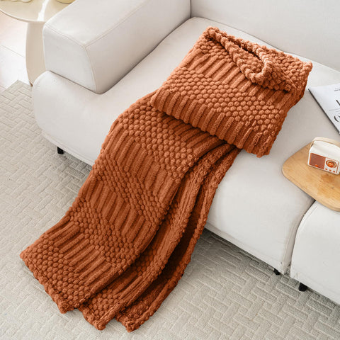 Lussena Rust Queen Bed Blanket on sofa as decorative accent