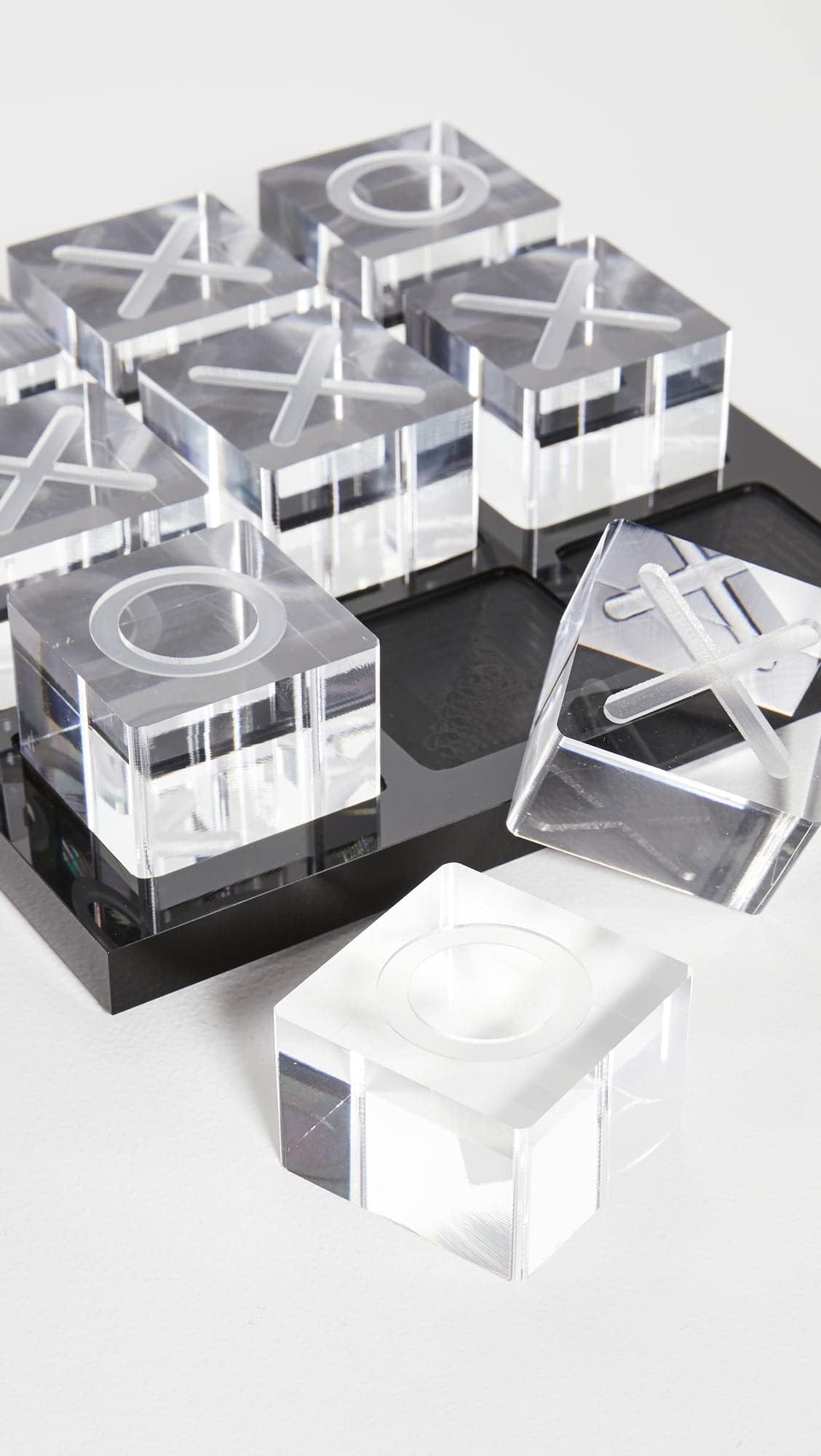 LuxLand Home acrylic XO board serves as an elegant coffee table centerpiece for leisure moments.