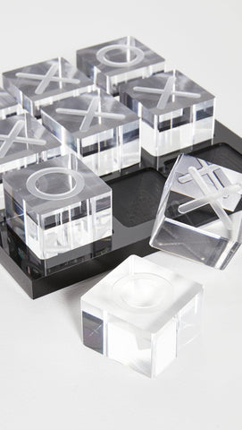LuxLand Home acrylic XO board serves as an elegant coffee table centerpiece for leisure moments.