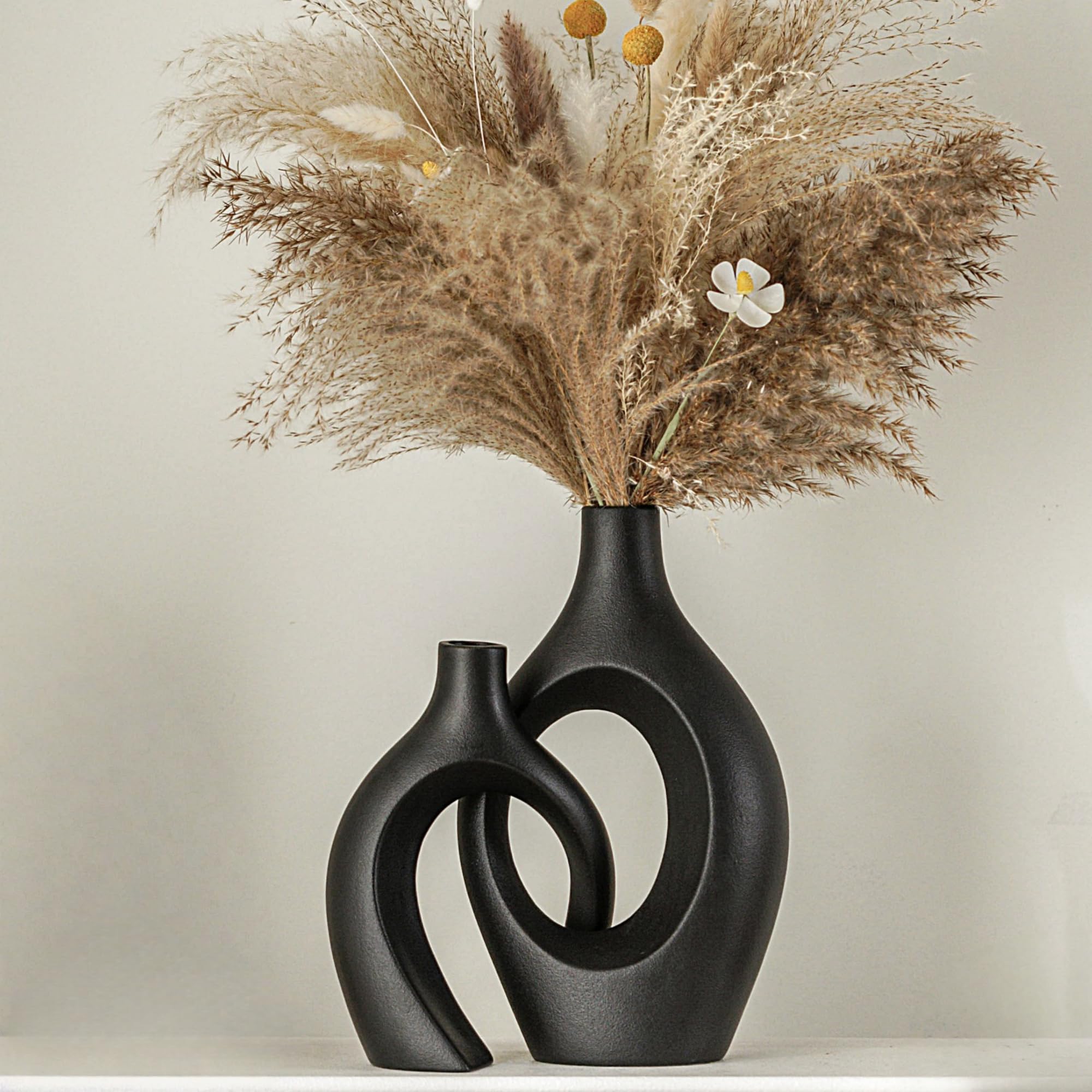 Lvases Snuggle Hollow tall vase in matte black for dramatic centerpieces.