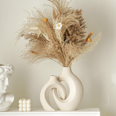 Lvases Snuggle Hollow short milky white vase complements small bouquets.