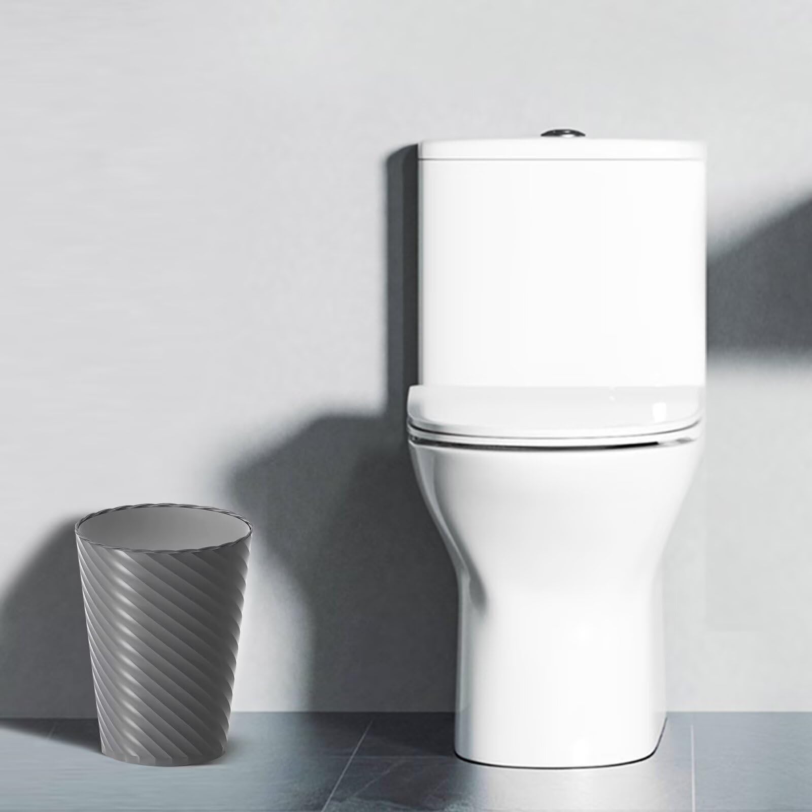 Lysam compact round trash can shown between toilet and vanity in a tight space