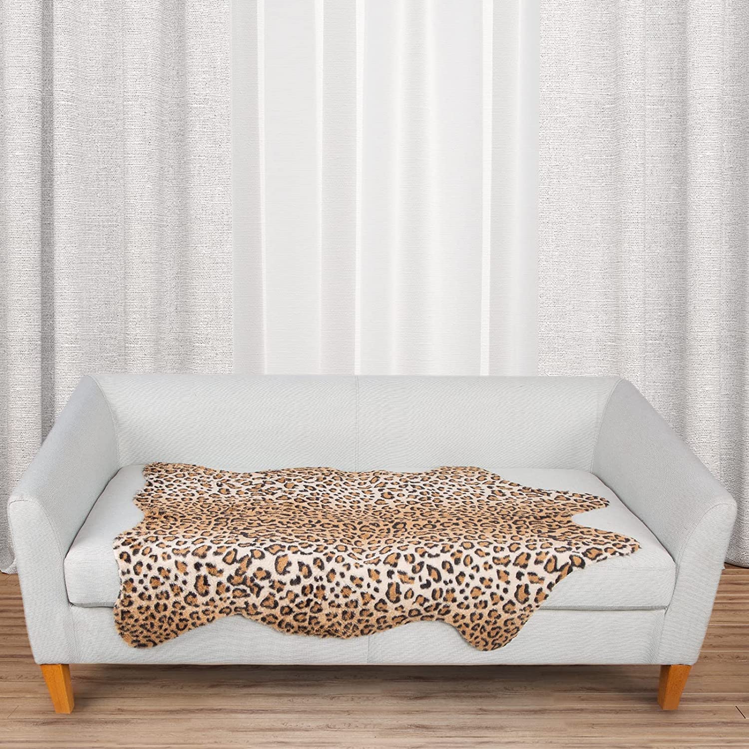 MACEVIA leopard rug under sofa stabilizes seating area