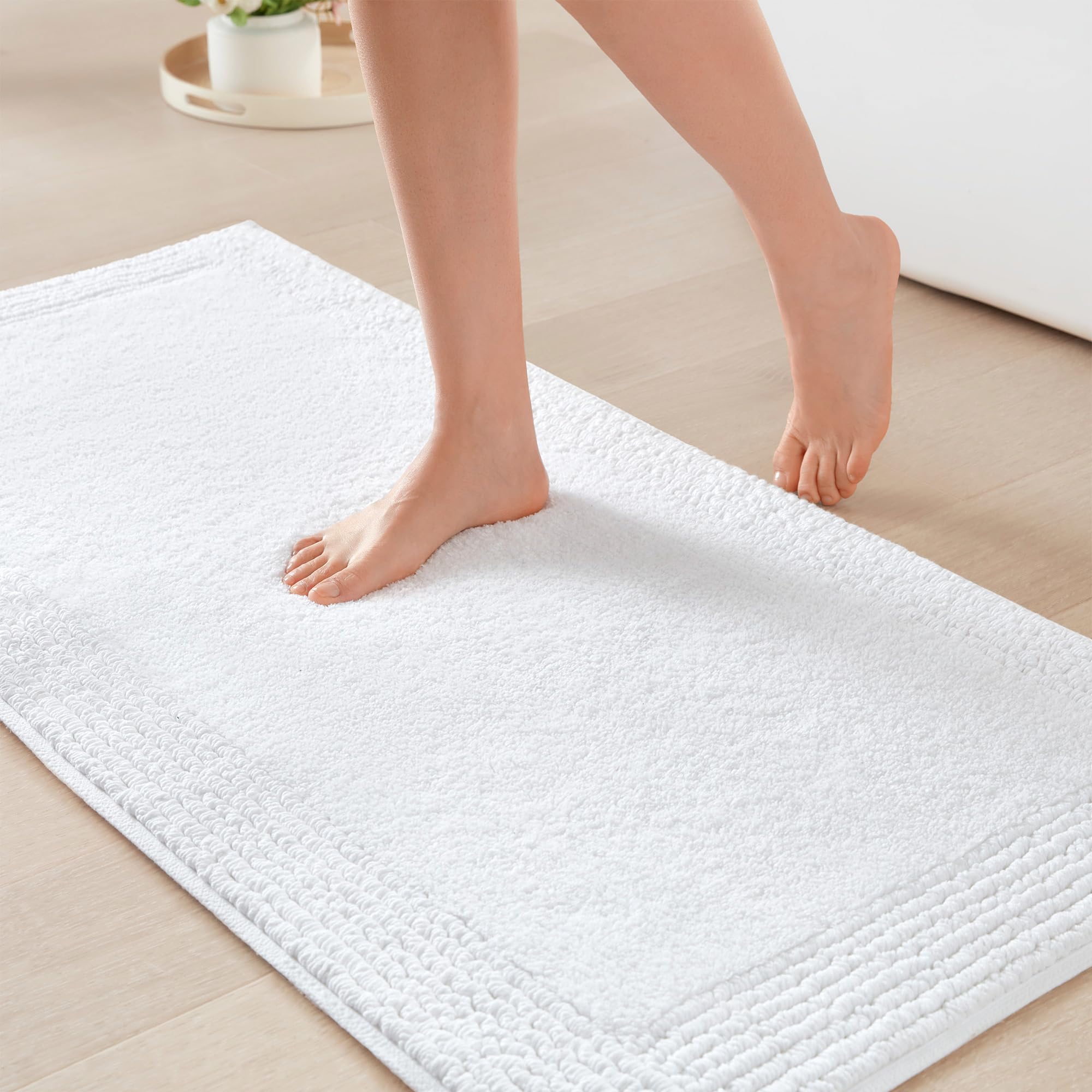 Madison Park Splendor white bath rug closeup showing dense tufted plush for luxury bathroom comfort.