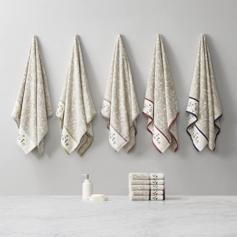 Embroidered floral hem detail on Madison Park Serene towels adds elegance