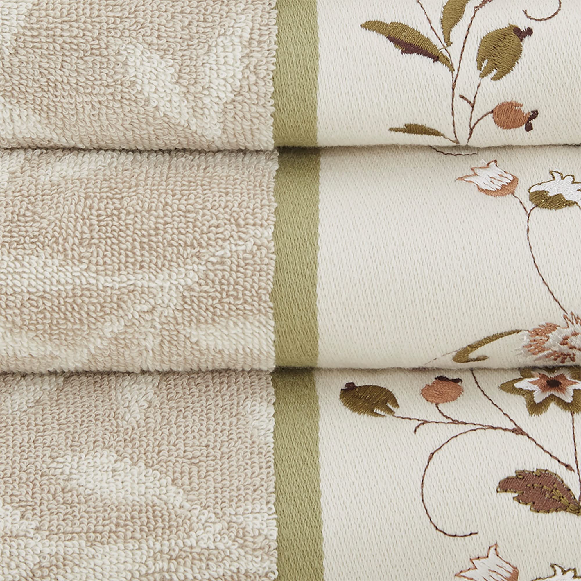Madison Park Serene fingertip towels show embroidered hem and green piping for guest bathroom accents