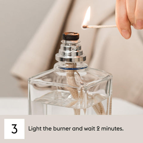 MAISON BERGER refill pouring into lamp reservoir invites simple ritual