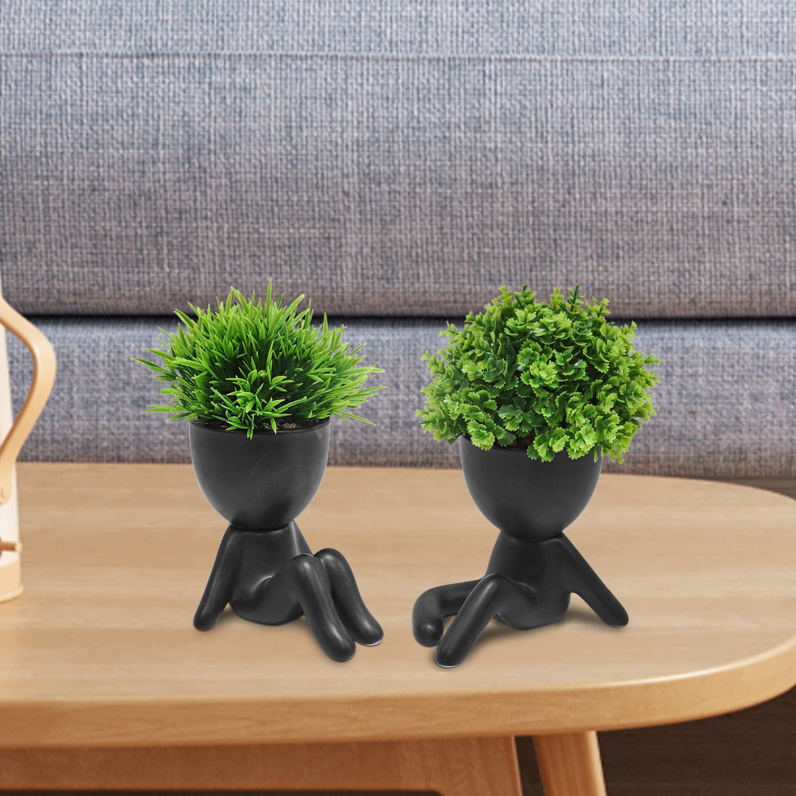 MAKHOT cute artificial plant in human-shaped pot creates a charming bookshelf display